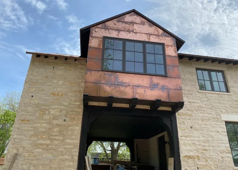 Copper metal panel facade on a stone building for Metal Roof Coating in Siloam Springs