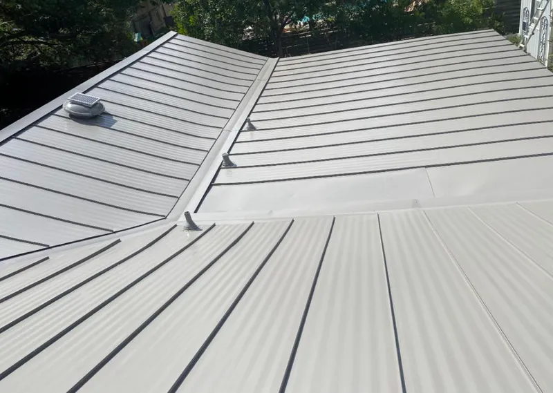 Solar attic fan installed on a metal roof for Roof Ventilation in Siloam Springs